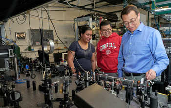 Cornell University's Chris Xu works with students.